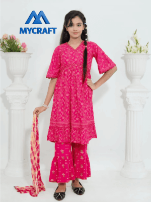 Young girl wearing a bright pink embroidered three-piece outfit from My Craft, featuring a floral kurta, matching flared trousers, and a printed dupatta, standing in a white studio with floral décor.