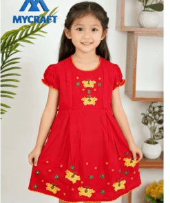 Girl wearing bright orange A-line embroidered frock from My Craft